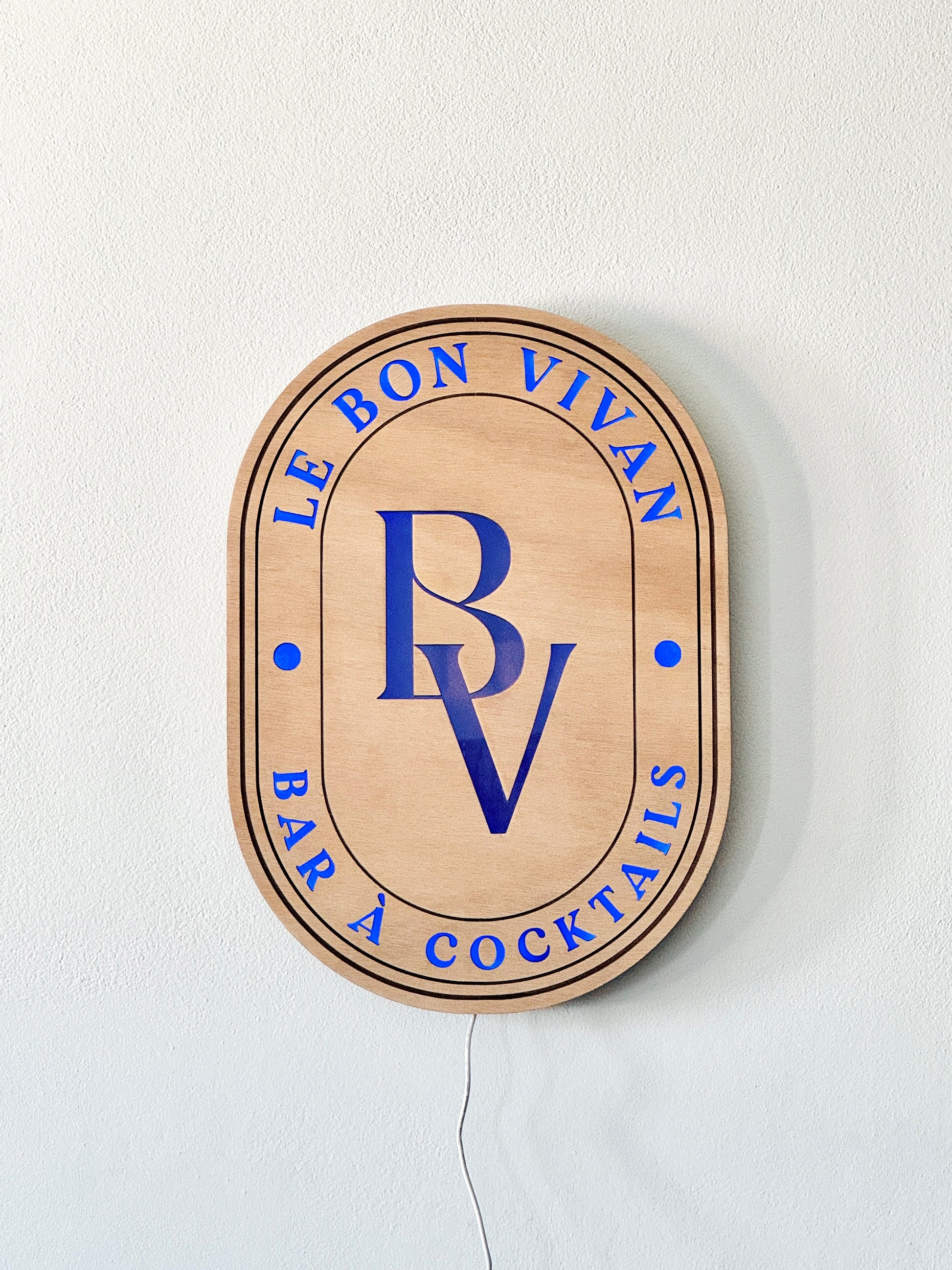 Handcrafted wooden LED sign with customizable logo and vibrant RGB lighting