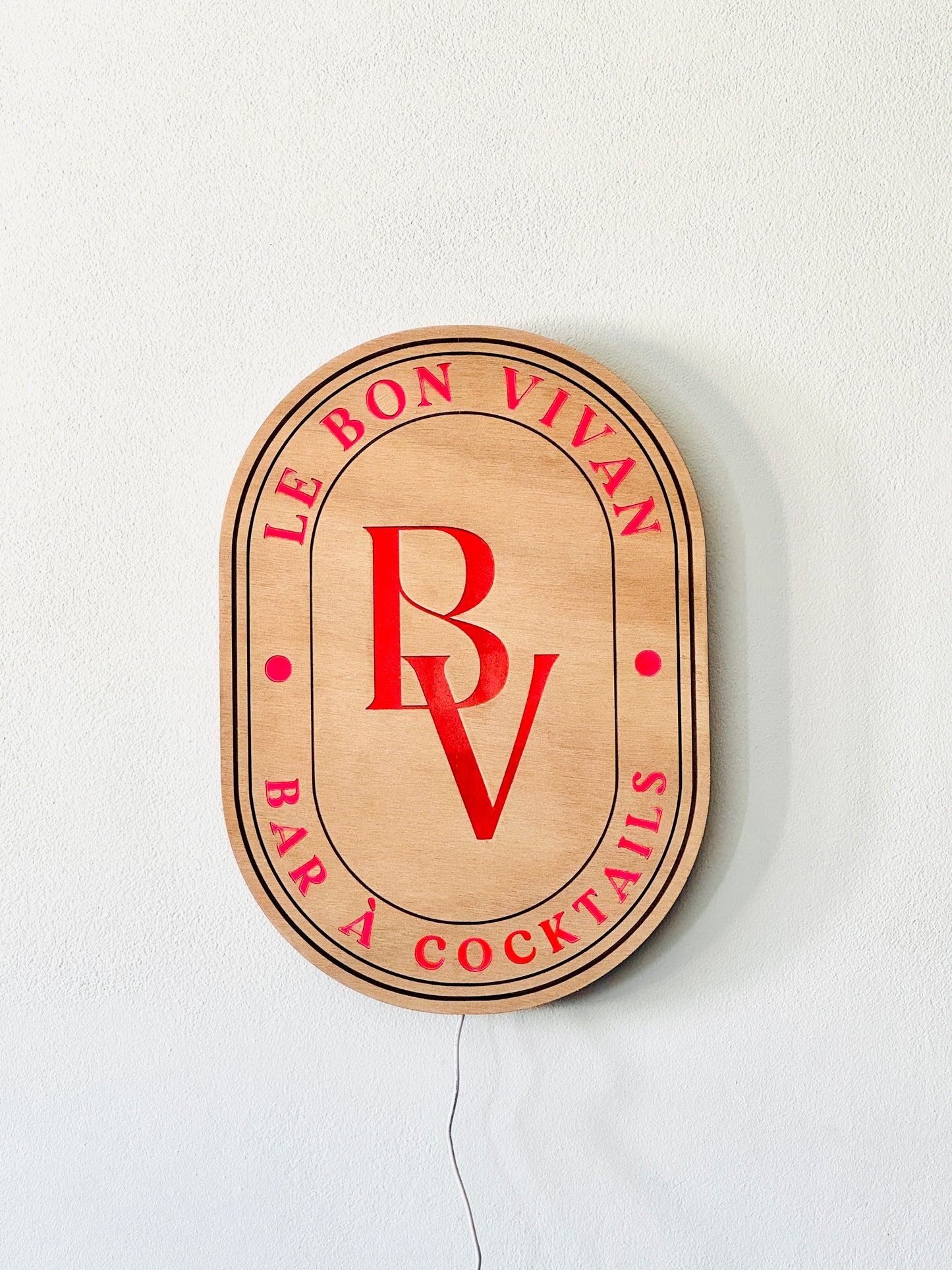 Custom-shaped LED logo sign in natural wood with adjustable multicolor lighting