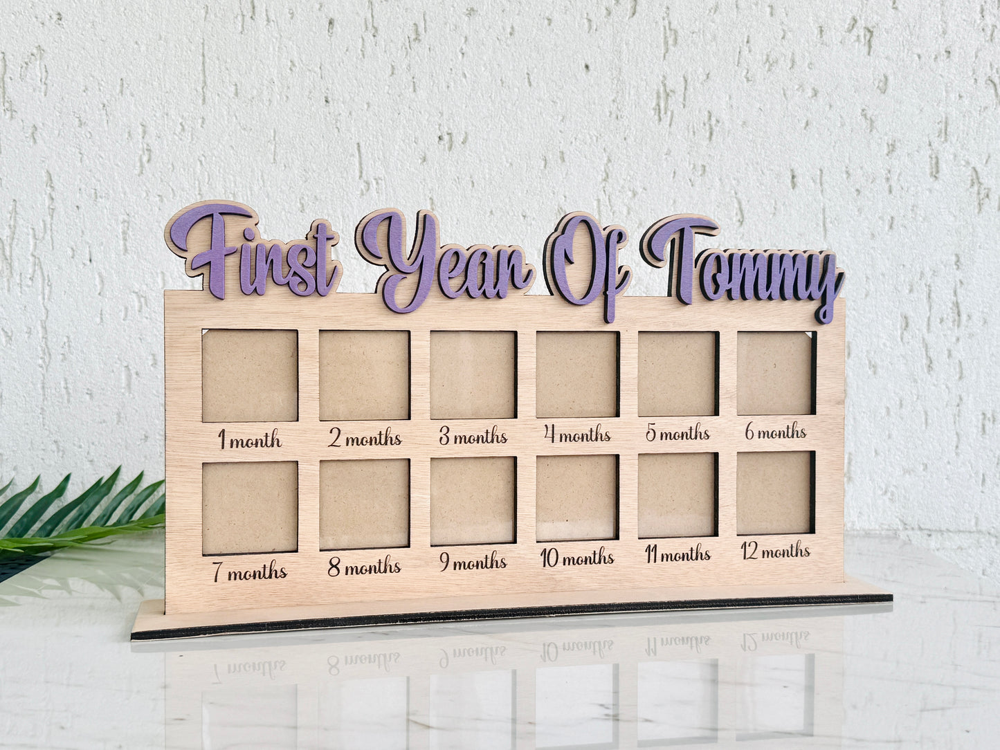 Wooden photo display with 'First Year and Baby Name' text 